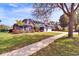 Stunning home with lush landscaping, American flag, and a circular driveway at 5115 Abisher Wood Ln, Brandon, FL 33511