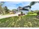 Well-maintained exterior with lush lawn, landscaping, and a spacious driveway leading to the garage at 5115 Abisher Wood Ln, Brandon, FL 33511