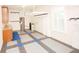 Spacious garage with storage cabinets, overhead rack, and tiled floor at 5115 Abisher Wood Ln, Brandon, FL 33511