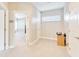 Bright hallway with a view into another room, showcasing the home's layout and design at 5115 Abisher Wood Ln, Brandon, FL 33511