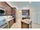 Spacious kitchen includes stainless appliances, granite counters, ample cabinets and tile floors at 5115 Abisher Wood Ln, Brandon, FL 33511