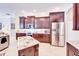 Well-equipped kitchen featuring granite countertops, stainless steel appliances, and dark wood cabinetry at 5115 Abisher Wood Ln, Brandon, FL 33511