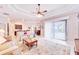 Open-concept living room featuring a ceiling fan, lots of natural light, and a view into the dining room at 5115 Abisher Wood Ln, Brandon, FL 33511