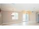 Bright living room features beautiful tile floors, decorative chandelier and large windows at 5115 Abisher Wood Ln, Brandon, FL 33511