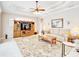 Comfortable living room with elegant furnishings, a coffered ceiling, and lots of natural light at 5115 Abisher Wood Ln, Brandon, FL 33511