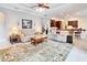 Spacious living room featuring comfortable seating and an open floor plan leading to the kitchen at 5115 Abisher Wood Ln, Brandon, FL 33511