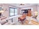 Bright living room with a large window overlooking the pool and a decorative wooden entertainment center at 5115 Abisher Wood Ln, Brandon, FL 33511