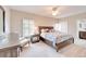 Relaxing bedroom with neutral colors, a large window with plantation shutters, and a ceiling fan at 5115 Abisher Wood Ln, Brandon, FL 33511