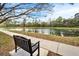 Scenic view of a tranquil pond surrounded by lush greenery and a inviting park bench at 5115 Abisher Wood Ln, Brandon, FL 33511
