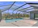 Screened in pool and spa overlooking a peaceful lake with mature landscaping at 5115 Abisher Wood Ln, Brandon, FL 33511