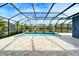 Enclosed pool area with a large pool and a beautiful view of the surrounding landscape at 5115 Abisher Wood Ln, Brandon, FL 33511