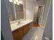 Bright bathroom with large vanity, framed mirror and tile floors at 5125 Palm Springs Blvd # 1203, Tampa, FL 33647
