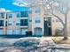 Attractive condo building featuring private garages, covered balconies, and lush landscaping at 5125 Palm Springs Blvd # 1203, Tampa, FL 33647