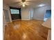Spacious living room with a large window and patio door, beautiful hardwood floors at 5125 Palm Springs Blvd # 1203, Tampa, FL 33647
