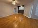 Living room featuring hardwood floors, ceiling fan, and access to balcony at 5125 Palm Springs Blvd # 1203, Tampa, FL 33647