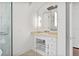 Bathroom vanity with a decorative mirror, stylish lighting, and marble countertop at 5128 W Longfellow Ave, Tampa, FL 33629