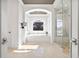 Luxurious bathroom with a soaking tub, walk-in shower, and arched window at 5128 W Longfellow Ave, Tampa, FL 33629