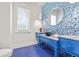 Stylish powder room with blue tile accents, designer sink, and marble countertop at 5128 W Longfellow Ave, Tampa, FL 33629