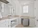 Elegant bathroom vanity area with marble countertop and built-in desk at 5128 W Longfellow Ave, Tampa, FL 33629