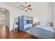 Comfortable bedroom with two beds, hardwood floors, a ceiling fan, and neutral walls at 5128 W Longfellow Ave, Tampa, FL 33629