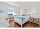 Comfortable bedroom with hardwood floors, window seat, and water view at 5128 W Longfellow Ave, Tampa, FL 33629