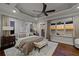 Serene bedroom with hardwood floors and water views features tray ceilings and neutral decor at 5128 W Longfellow Ave, Tampa, FL 33629