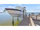 View of a boat on a boat lift and the dock, enhancing waterfront living and easy boating access at 5128 W Longfellow Ave, Tampa, FL 33629