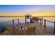 Waterfront home features a private dock with boat lift and seating area for enjoying waterfront sunsets at 5128 W Longfellow Ave, Tampa, FL 33629