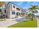 Elegant waterfront home showcases a private pool, lush green lawn, and a dock extending into the serene water at 5128 W Longfellow Ave, Tampa, FL 33629