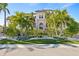 Elegant Mediterranean-style home with mature palm trees and manicured landscaping at 5128 W Longfellow Ave, Tampa, FL 33629