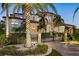 Stately gated home featuring lush landscaping, circular driveway, and elegant exterior details at 5128 W Longfellow Ave, Tampa, FL 33629