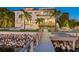 Beautiful home at twilight featuring a pool, dock, and lush tropical landscaping on waterfront property at 5128 W Longfellow Ave, Tampa, FL 33629