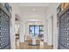 Spacious foyer with elegant light fixture, arched doorways, and beautiful views of the water and outdoor living area at 5128 W Longfellow Ave, Tampa, FL 33629