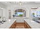 Kitchen featuring double islands with water views, brick flooring and dual sinks at 5128 W Longfellow Ave, Tampa, FL 33629