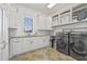 Well-equipped laundry room with modern appliances, plenty of counter space, and cabinet storage at 5128 W Longfellow Ave, Tampa, FL 33629