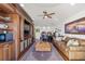 Spacious living room with wooden built-ins, hardwood floors, a leather couch, and natural light at 5128 W Longfellow Ave, Tampa, FL 33629