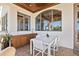 Stylish outdoor dining area featuring a sleek wet bar, arched windows, and comfortable seating for elegant entertaining at 5128 W Longfellow Ave, Tampa, FL 33629