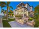 Inviting outdoor space with a modern fireplace, comfortable seating, and a private pool with waterfront views at 5128 W Longfellow Ave, Tampa, FL 33629