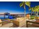 Waterfront home with outdoor fire pit, seating, boat dock, and palm tree views at 5128 W Longfellow Ave, Tampa, FL 33629