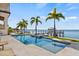 Lush backyard oasis featuring a pool, spa, and waterfront views, creating a perfect blend of luxury and nature at 5128 W Longfellow Ave, Tampa, FL 33629