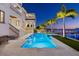 Luxury home with private waterfront pool, a large patio, and second story balcony at 5128 W Longfellow Ave, Tampa, FL 33629