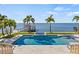 Gorgeous backyard pool with integrated spa and lush palms, offering serene water views and private dock at 5128 W Longfellow Ave, Tampa, FL 33629