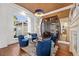 Beautiful sitting room features hardwood floors, large windows, and an eye-catching wine cellar at 5128 W Longfellow Ave, Tampa, FL 33629