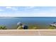 Breathtaking waterfront view featuring a private dock and boat lift against a serene ocean backdrop at 5128 W Longfellow Ave, Tampa, FL 33629