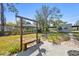Well-maintained backyard with bench seating, green space, and mature trees at 6202 Tennessee Ave, New Port Richey, FL 34653