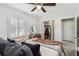Bedroom featuring a ceiling fan, plantation shutters, and an open closet at 6202 Tennessee Ave, New Port Richey, FL 34653