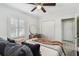 Bedroom featuring a ceiling fan, plantation shutters, and a closet with double doors at 6202 Tennessee Ave, New Port Richey, FL 34653