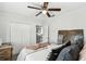 Bedroom with ceiling fan, closet with double doors, and a view into the kitchen at 6202 Tennessee Ave, New Port Richey, FL 34653