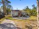 Cozy single-story home featuring a gravel front yard and a vibrant pink entry door at 6202 Tennessee Ave, New Port Richey, FL 34653