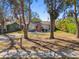 Charming home with gravel yard, coral door, mature trees, and curb appeal at 6202 Tennessee Ave, New Port Richey, FL 34653
